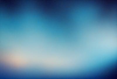 The primary subject of the image is a blue sky with a few clouds. The setting is a vast, open space with no visible landmarks or objects. The visual style is a natural, outdoor scene. The colors and mood are predominantly blue, creating a calm and serene atmosphere.