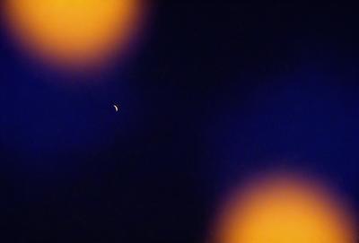 The primary subject of the image is a single star in the night sky. The setting is a dark, starry night with a few other stars visible in the background. The visual style is a photo of the night sky, capturing the beauty of the starry landscape. The colors and mood of the image are predominantly dark and serene, with the star being the main focal point.
