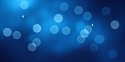 The primary subject of the image is a blue background with a pattern of white dots. The setting appears to be a dark room, and the visual style is a digital art or illustration. The dominant colors are blue and white, creating a calm and serene atmosphere.