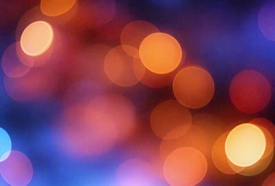 The primary subject of the image is a brightly lit scene with a focus on the colorful lights. The setting is a dark background, which contrasts with the vibrant colors of the lights. The visual style of the image is a combination of a photo and digital art, creating a unique and eye-catching effect. The colors and mood of the image are predominantly warm and inviting, with the lights emitting a sense of energy and excitement.