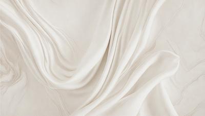 The primary subject of the image is a white sheet of fabric, which is the main object, scene, or focus of the image. The setting or background is a white sheet of fabric, and the visual style is a photo. The colors and mood of the image are predominantly white, giving it a clean and minimalist appearance.