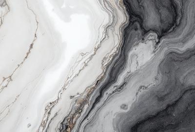The primary subject of the image is a marble countertop with a black and white pattern. The setting is a kitchen, and the visual style is a close-up of the countertop. The colors and mood of the image are predominantly black and white, giving it a classic and elegant appearance.