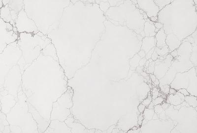 The primary subject of the image is a white marble wall with a pattern of holes and bumps. The setting is a room with a white marble floor. The visual style is a close-up of the marble wall, showcasing its unique texture. The colors and mood of the image are predominantly white, giving it a clean and elegant appearance.