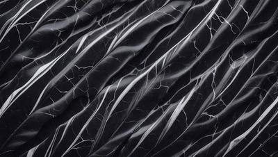 The primary subject of the image is a black and white photograph of a patterned surface. The setting is a black background, and the visual style is a close-up of the pattern. The dominant colors are black and white, creating a classic and timeless atmosphere.