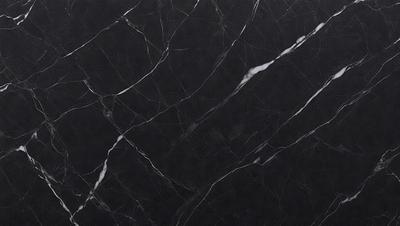 The primary subject of the image is a black marble countertop. The setting is a kitchen, with the countertop being the main focus of the scene. The visual style is a close-up of the marble countertop, showcasing its texture and pattern. The colors and mood of the image are predominantly dark, with the black marble countertop being the main source of contrast.