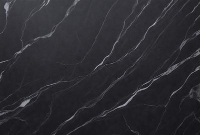 The primary subject of the image is a black marble countertop. The setting is a kitchen, with the countertop being the main focus of the scene. The visual style is a close-up of the marble countertop, showcasing its texture and pattern. The colors and mood of the image are predominantly dark, with the black marble countertop being the main source of contrast.