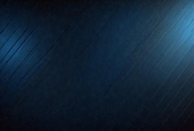 The primary subject of the image is a blue sky with a few clouds. The setting is a dark blue background, which creates a contrasting effect with the sky. The visual style appears to be a photo, as it captures the natural beauty of the sky. The colors and mood of the image are predominantly dark and moody, with the blue sky and clouds providing a sense of depth and tranquility.