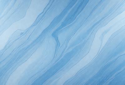 The primary subject of the image is a blue and white swirling pattern, which appears to be a design or a part of a larger surface. The setting is a blue background, which complements the swirling pattern. The visual style is a combination of a photo and a digital art, as the swirling pattern is created using a digital medium. The colors and mood of the image are predominantly blue and white, giving it a calm and soothing atmosphere.