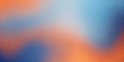 The primary subject of the image is a colorful, abstract background featuring a mix of orange, blue, and white hues. The setting is a blue sky, which serves as the backdrop for the vibrant colors. The visual style of the image is a combination of digital art and illustration, creating a unique and eye-catching design. The dominant colors and overall atmosphere of the image are energetic, lively, and full of life.