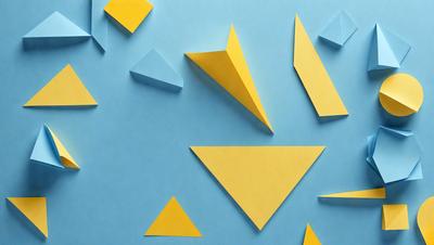 The primary subject of the image is a collection of yellow triangles, which are arranged on a blue surface. The setting appears to be a workspace or a creative environment, as the triangles are cut out of paper and placed on the blue background. The visual style of the image is a combination of digital art and illustration, as the triangles are carefully crafted and placed on the blue surface. The colors and mood of the image are predominantly yellow and blue, creating a vibrant and lively atmosphere.