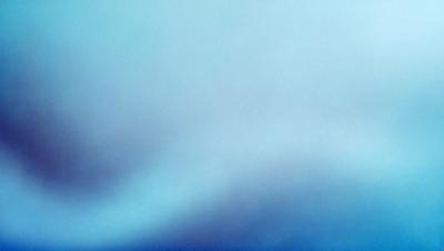 The primary subject of the image is a cloudy blue sky. The setting is a vast, open space with no visible landmarks or objects. The visual style is a natural, outdoor scene. The colors and mood are predominantly blue, creating a calm and serene atmosphere.