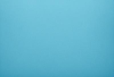 The primary subject of the image is a large, empty blue sky. The setting is a vast, open space with no visible landmarks or objects. The visual style is a natural, untouched landscape. The colors and mood are predominantly blue, creating a calm and serene atmosphere.