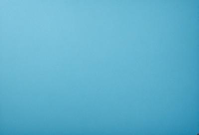 The primary subject of the image is a large, empty blue sky. The setting is a vast, open space with no visible landmarks or objects. The visual style is a natural, untouched landscape. The colors and mood are predominantly blue, creating a calm and serene atmosphere.