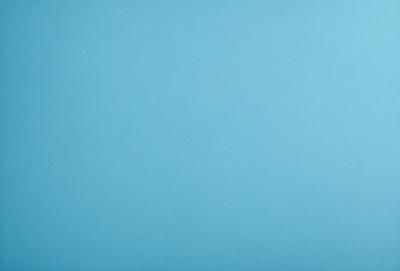 The primary subject of the image is a large, empty blue sky. The setting is a vast, open space with no visible landmarks or objects. The visual style is a natural, untouched landscape. The colors and mood are predominantly blue, creating a calm and serene atmosphere.