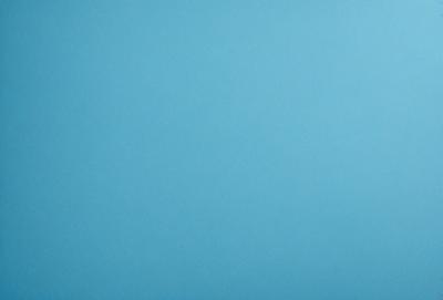 The primary subject of the image is a large, empty blue sky. The setting is a vast, open space with no visible landmarks or objects. The visual style is a natural, untouched landscape. The colors and mood are predominantly blue, creating a calm and serene atmosphere.