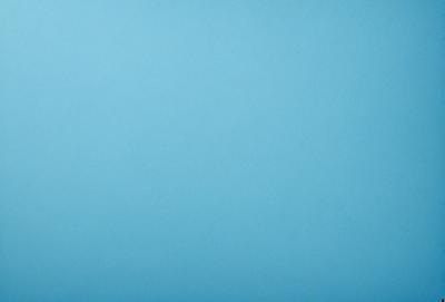 The primary subject of the image is a large, empty blue sky. The setting is a vast, open space with no visible landmarks or objects. The visual style is a natural, outdoor scene with a focus on the sky. The colors and mood are predominantly blue, creating a calm and serene atmosphere.