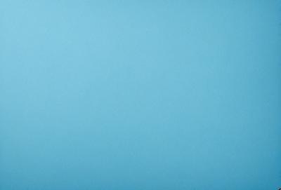 The primary subject of the image is a large, empty blue sky. The setting is a vast, open space with no visible landmarks or objects. The visual style is a natural, outdoor scene with a focus on the sky. The colors and mood are predominantly blue, creating a calm and serene atmosphere.