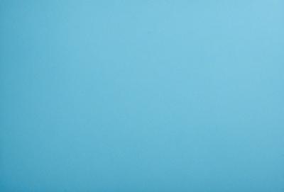 The primary subject of the image is a large, open, and empty blue sky. The setting is a vast, cloudless expanse, with no visible landmarks or objects. The visual style is a natural, untouched landscape, with no indication of digital manipulation or artistic elements. The colors and mood are predominantly blue, conveying a sense of tranquility and vastness.