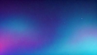The primary subject of the image is the night sky, which is filled with stars. The setting is a dark, star-filled sky, and the visual style is a photo. The colors and mood of the image are predominantly dark and serene, with the stars providing a sense of depth and beauty.