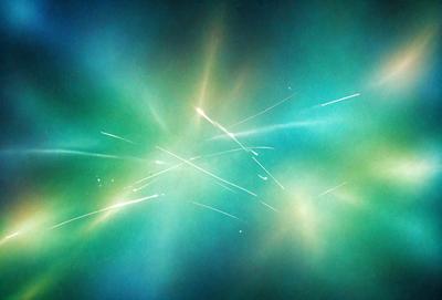 The primary subject of the image is a bright, colorful, and vibrant display of light, possibly resembling a firework or a nebula. The setting is a dark, starry sky, which contrasts with the bright light. The visual style appears to be a combination of a photo and digital art, creating a unique and captivating scene. The colors and mood of the image are predominantly blue and green, with a sense of wonder and awe.