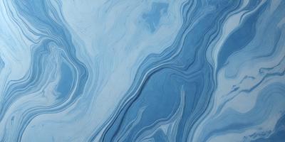 The primary subject of the image is a blue and white ocean wave. The setting is the ocean, with the wave being the main focus of the image. The visual style is a photo of the ocean, capturing the beauty of the wave. The dominant colors are blue and white, creating a serene and calming atmosphere.