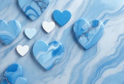 The primary subject of the image is a collection of blue heart-shaped tiles or decorations. These blue hearts are arranged on a blue marble surface, which serves as the setting and background of the scene. The visual style of the image is a close-up of the blue hearts, showcasing their unique design and color. The overall atmosphere of the image is calm and serene, with the blue hearts creating a sense of harmony and unity.