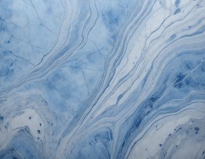 The primary subject of the image is a blue and white marbled surface, which appears to be a tile or a piece of artwork. The setting is a room with a blue and white color scheme. The visual style is a close-up of the marbled surface, showcasing its intricate patterns and textures. The colors and mood of the image are predominantly blue and white, creating a calm and serene atmosphere.