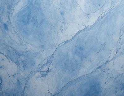 The primary subject of the image is a blue marble wall with a pattern of swirls. The setting is a room with a blue marble floor. The visual style is a close-up of the marble wall, showcasing the intricate swirl pattern. The colors and mood of the image are predominantly blue, creating a calm and serene atmosphere.