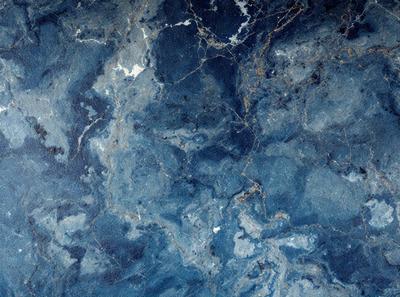 The primary subject of the image is a blue marble wall with a pattern of white spots. The setting is a room with a blue marble floor. The visual style is a close-up of the marble wall, showcasing its unique texture and design. The dominant colors are blue and white, creating a calm and serene atmosphere.