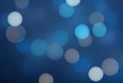 The primary subject of the image is a blue background with a pattern of white lights. The setting appears to be a nighttime scene, possibly a cityscape or a space with a starry sky. The visual style of the image is a combination of a photo and digital art, creating a unique and captivating atmosphere. The dominant colors are blue and white, with the white lights adding a sense of depth and contrast to the overall mood of the image.