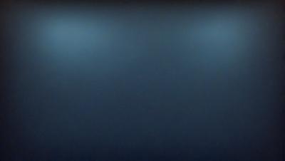 The primary subject of the image is a large, dark blue wall. The setting is a room with a blue background, and the visual style is a photo. The dominant colors are blue and black, creating a moody atmosphere.