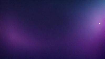The primary subject of the image is a purple background. The setting is a dark, purple sky, which creates a moody atmosphere. The visual style is a photo, capturing the purple sky as the main focus. The colors and mood of the image are predominantly purple, giving it a dramatic and mysterious appearance.