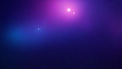 The primary subject of the image is a purple sky with two bright stars in it. The setting is a night sky, and the visual style appears to be a photo. The colors and mood of the image are predominantly purple, creating a serene and peaceful atmosphere.