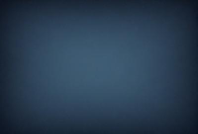 The primary subject of the image is a blue background. The setting is a dark, empty space with no visible objects or people. The visual style is a simple, monochromatic design. The colors and mood are predominantly dark and moody, with the blue background creating a sense of depth and mystery.