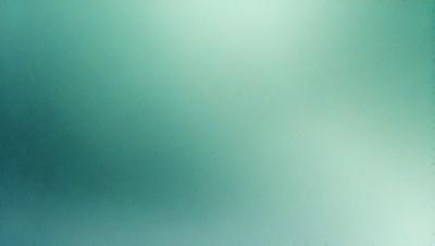 The primary subject of the image is a green background, which appears to be a wall or a surface. The setting is a room with a green color scheme. The visual style is a close-up of the green background, which gives the image a clean and minimalistic appearance. The colors and mood of the image are predominantly green, creating a calm and serene atmosphere.
