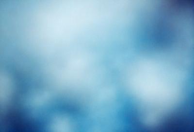 The primary subject of the image is a cloudy blue sky. The setting is a vast, open space with no visible landmarks or objects. The visual style is a natural, outdoor scene. The colors and mood are predominantly blue, creating a calm and serene atmosphere.