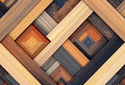 The primary subject of the image is a wooden square with a pattern of different wood colors. The setting is a wooden floor, and the visual style is a close-up of the wooden square. The colors and mood of the image are warm and natural, with the various shades of wood creating a visually appealing pattern.
