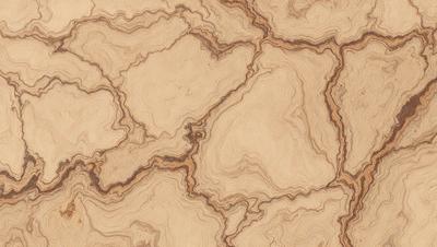 The primary subject of the image is a wooden surface with a unique and intricate pattern. The setting is a close-up view of the wooden surface, showcasing the detailed design. The visual style is a close-up of the wooden surface, which gives a sense of depth and texture. The colors and mood of the image are warm and natural, with the wooden surface being the main focus.