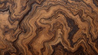 The primary subject of the image is a wooden table with a unique and intricate pattern on its surface. The table appears to be made of wood and has a distinctive texture, giving it a natural and rustic appearance. The setting is indoors, with the table being the main focus of the scene. The visual style of the image is a close-up of the wooden table, showcasing its intricate pattern and texture. The colors in the image are predominantly earthy tones, such as browns and greens