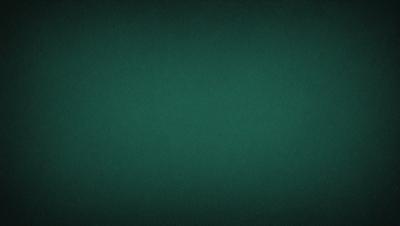 The primary subject of the image is a green background. The setting is a dark room, and the visual style is a photo. The colors and mood of the image are predominantly green, creating a calm and serene atmosphere.