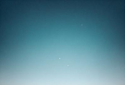 Primary subject: Two stars in the sky
Setting/background: A clear blue sky
Visual style: Photo
Colors and mood: Blue and clear, with a sense of tranquility