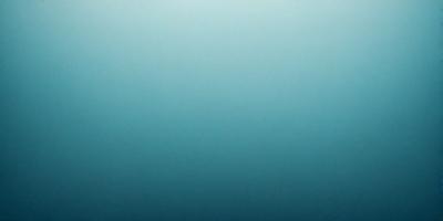 The primary subject of the image is a large body of water, which appears to be a deep blue ocean. The setting is a vast expanse of water, with no visible land or other objects. The visual style of the image is a close-up of the water, showcasing its depth and beauty. The colors and mood of the image are predominantly blue, creating a serene and tranquil atmosphere.