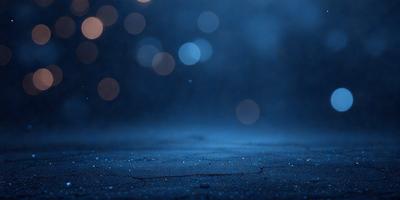 The primary subject of the image is a close-up of a wet, black surface with a blue hue. The setting appears to be a dark, possibly underground environment. The visual style of the image is a photo, capturing the details of the wet surface and the blue hue. The colors and mood of the image are predominantly dark and moody, with the blue hue adding a touch of mystery to the scene.
