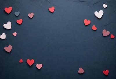 The primary subject of the image is a collection of red hearts arranged on a blue surface. The hearts are scattered across the surface, creating a visually appealing pattern. The setting appears to be a dark room, which adds a sense of mystery and intrigue to the scene. The visual style of the image is a combination of digital art and illustration, as the hearts are carefully placed and the overall composition is well-executed. The dominant colors in the image are red and blue, which evoke a sense of warmth and energy.