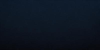 The primary subject of the image is a dark blue sky. The setting is a vast, open space with no visible landmarks or objects. The visual style is a natural, outdoor scene. The colors and mood are predominantly dark and moody, with the blue sky serving as the main focal point.