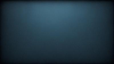 The primary subject of the image is a blue background. The setting is a dark, empty space with no visible objects or people. The visual style is a black and white photo, giving it a classic and timeless appearance. The colors and mood are predominantly dark and moody, creating a sense of mystery and depth.