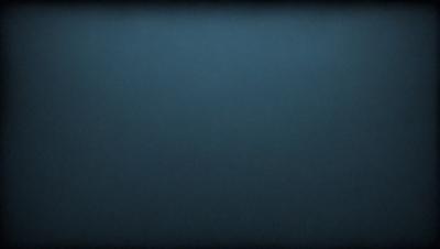 The primary subject of the image is a blue background. The setting is a dark, empty space with no visible objects or people. The visual style is a simple, monochromatic design. The colors and mood are predominantly dark and moody, with the blue background creating a sense of depth and mystery.