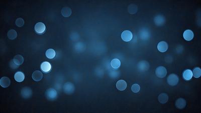 The primary subject of the image is a blue background with a pattern of white lights. The setting appears to be a dark room, and the visual style is a combination of a photo and digital art. The dominant colors are blue and white, creating a calm and serene atmosphere.