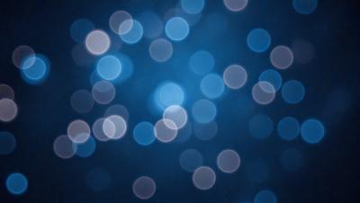 The primary subject of the image is a blue background with a pattern of white lights. The setting appears to be a dark room, and the visual style is a combination of a photo and digital art. The dominant colors are blue and white, creating a calm and serene atmosphere.
