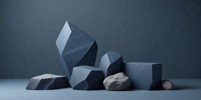 The primary subject of the image is a collection of blue and grey geometric shapes, which are arranged in a visually appealing manner. The setting is a grey background, which provides a clean and minimalist backdrop for the shapes. The visual style of the image is a combination of photo and digital art, creating a unique and artistic representation of the geometric shapes. The dominant colors in the image are blue and grey, which contribute to a calm and sophisticated atmosphere.